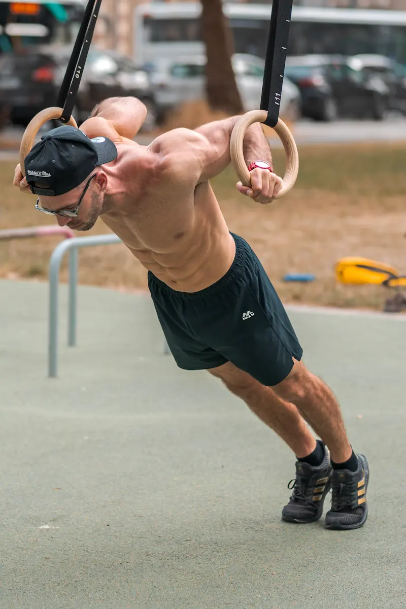 athlete training on gymnastic rings at Bondi Beach Sydney athlete training on gymnastic rings at Bondi Beach Sydney